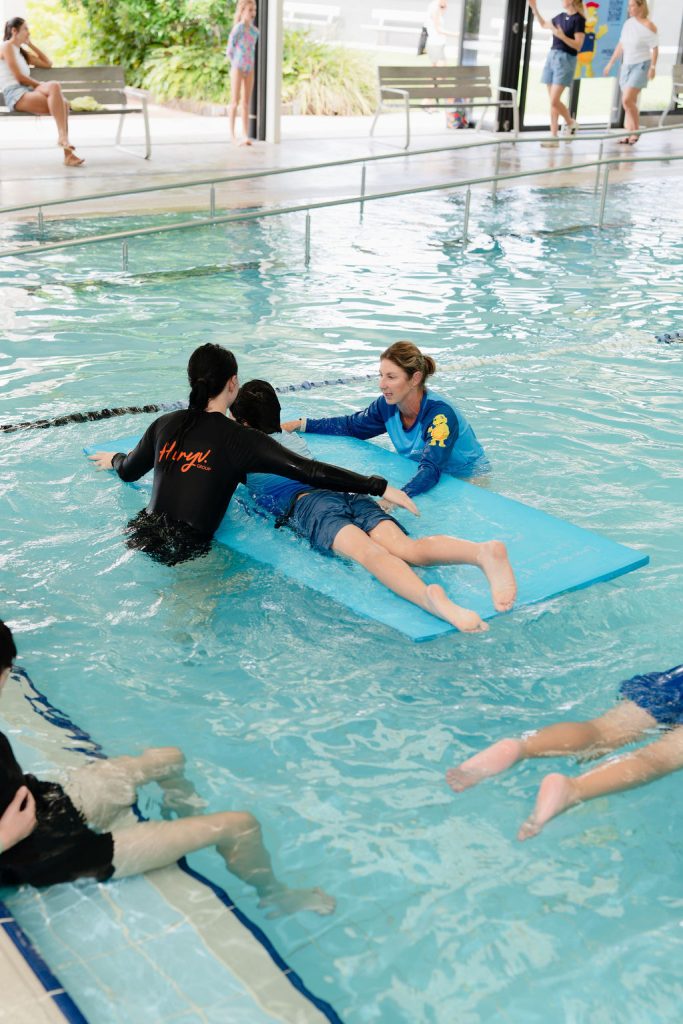 Instructor guiding a participant through the water